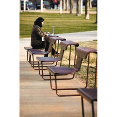 a woman sitting on a bench with her legs crossed