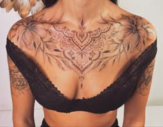 a woman with tattoos on her chest and back