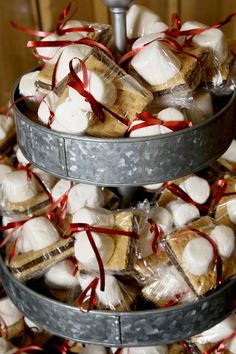 three tiered trays filled with marshmallows and pretzels