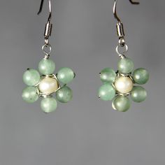 This delicate daisy earrings are handmade using jade and pearl. It is a perfect earring for everyday wear and gifts for your loved one. The size of the earrings is 1/2 inches, 12mm. ;-) My contact number: 626-379-1904. Please contact me if you would like to order multiples or customize a design for your special event, I will be pleased to give you a discount on a quantity order. ;-) Purchases will be shipped within 1-3 business days. In case of occasional shortage of beads material, purchases wi Elegant Flower Shaped Jade Jewelry, Handmade Pearl Dangle Flower Earrings, Handmade Flower Pearl Earrings, Handmade Pearl Flower Jewelry, Handmade Green Pearl Earrings For Gift, Pearl Flower-shaped Earrings As A Gift, Handmade Flower-shaped Pearl Earrings, Elegant Round Beads Flower Earrings As Gift, Elegant Flower Earrings With Round Beads As Gift