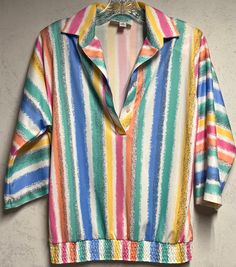 Rainbow-striped blouse features button closure at chest and elastic waistband. Shirt has a slight v-neck opening and includes 3/4 length sleeves. This item is listed as a womens 10 and is in excellent vintage condition with no holes or stains noted. Cheap Vintage Striped Tops, Preppy Sweater, Yellow Blouse, Striped Blouse, Rainbow Stripes, Sweater Vest, Length Sleeve, Womens Clothing Tops, Blouses For Women