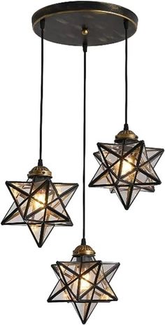 three lights hanging from the ceiling with stars on them and one light in the middle