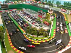 there are many cars and trucks on the track