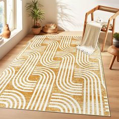 an area rug in the corner of a room with a chair and potted plant