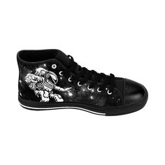 "You'll love these Womens Epic Black and White Astronaut Galaxy High Tops! With a black and white high contrast astronaut galaxy design with stars and space dust they're sure to get noticed, look cute and get compliments. A perfect christmas or birthday gift idea for any fan of the stars, space travel, science fiction, astronauts and all things astronomy or intergalactic. These durable classic canvas sneakers are super comfy to walk in with extra cushion and support and feature an advanced fade Black High-top Sneakers With Graphic Print For Streetwear, Black Graphic Print High-top Sneakers For Streetwear, Black Mid-top Sneakers With Graphic Print, Black Graphic Print Mid-top Sneakers, Black Graphic Print High-top Sneakers, Black Lace-up High-top Sneakers With Graphic Print, High-top Star Print Sneakers For Streetwear, Casual Black Sneakers With Star Print, Black And White Astronaut