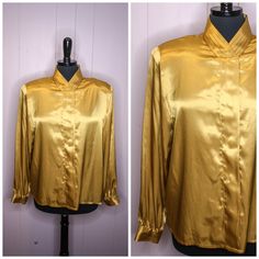 "Vintage metallic gold button up blouse top 100% polyester High pleated collar  Hidden panel button up closure Long sleeves with buttoned cuffs Padded shoulders The label sizes this as a US women's size 12 but please see the measurements given below for accurate sizing Maker - Hasting & Smith Condition - Excellent vintage condition Measurements -  Shoulders - 18\" (46cm) Chest - 22\" (56cm) pit to pit, 44\" (112cm) full Waist - 44\" (112cm) Length - 25\" (64cm) Sleeves - 17\" (43cm) pit to pit, Classic Gold Blouse For Workwear, Gold Blouse With Button Closure For Formal Occasions, Gold Collared Blouse For Fall, Gold Long Sleeve Blouse For Work, Gold Collared Blouse For Formal Occasions, Gold Blouse With Button Closure For Fall, Gold Collared Top For Workwear, Gold Collared Top For Work, Gold Formal Blouse With Buttons