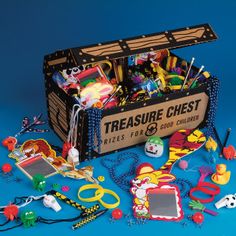 a box filled with lots of toys on top of a blue surface