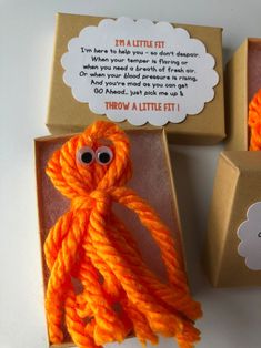 an orange octopus toy sitting inside of a box next to a brown package with the message i'm little bit written on it