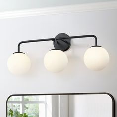 This 3-Light bathroom vanity light fixture is a great blend of mid-century classic and contemporary styles. It features 3 frosted white opal glass shades and gently arched arms in matte black, which looks low-profile but has the elegant and minimalist aesthetics. The glass globe wall light is an eye-catching and focal piece to help build a timeless interior decor, which is ideal for over bathroom mirror or in a bedroom, powder room or living room to add chic urban romance. True Fine Carousel 26. Vanity Lighting Over Mirror, Black Bathroom Light Fixtures, Bathroom Vanity Light Fixture, Black Bathroom Light, Globe Wall Light, Vanity Lights Bathroom, Cabin Bathrooms, Black Vanity Light, Light Fixtures Bathroom Vanity