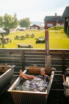 a person laying in an outdoor hot tub