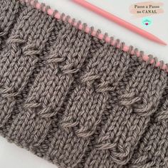 the crochet stitch is next to a knitting needle