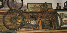 an old motorcycle is on display in a museum