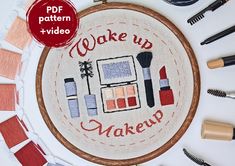 a cross stitch pattern with the words wake up makeup on it, surrounded by other sewing supplies