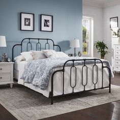 a bedroom with blue walls and white furniture