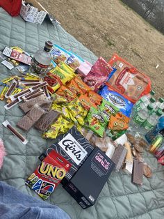 a pile of food sitting on top of a bed next to a person's feet