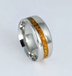 a wedding ring with an orange and yellow stone inlayed to the inside of it