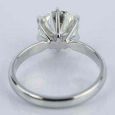 a white gold ring with an oval cut diamond