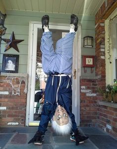 a man is standing on his back legs in front of a door with one foot up