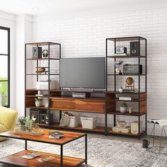 a living room filled with furniture and a flat screen tv on top of a wooden shelf