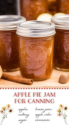 three jars filled with apple pie jam on top of a wooden table next to cinnamons