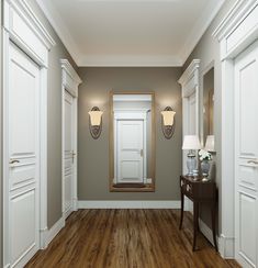 an empty hallway with two lamps and a mirror on the wall next to a table