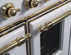 an oven with brass handles and knobs on the front door is shown in this image