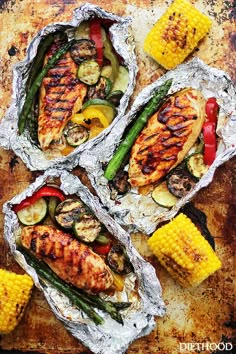 grilled chicken and vegetables in tin foil with corn on the cob