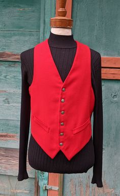 This handsome vest will set off your weekend riding attire so well, with a brilliant flash of bright color and lovely tailoring. Red worsted wool front with acetate lining/back; 6 button front placket, faux cuffed front pockets, deep v-neck, strap/buckle adjustment back, excellent condition. No label or marked size but measures like a 40, c1960s. The following measurements were taken with the garment lying FLAT and recorded in inches, please be sure and DOUBLE the appropriate measurements: Shoul Mens Vests, Vest Outfits, Neck Strap, Western Outfits, Bright Color, Week End, Deep V Neck, Vintage Men, 1960s