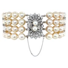 Find vintage glory in this outstanding mid-century jeweled Art-Deco style pearl bracelet. Exquisite, featuring a sparkling diamond covered white gold ornamental clasp which brilliantly hosts four strands of lustrous matching hand-knotted AAA creamy white round 8 mm+ Akoya pearls creating this beautiful formal wear jeweled accessory that is perfect for bridal and special occasions. Its spectacular diamond covered oblong-shape white gold clasp measures a generous 1 inch by 1/2 inch and is graced with fifty-four round faceted white diamonds, 1.20 carat TW along with two complementing 6mm pearls to accent its center. In addition, positioned along the multiple strands of beautiful pearls are three white gold bar stations each displaying three decorative prong-set diamonds accents that together Pearl Necklace Vintage, Pearl Bracelets, Multi Strand Bracelet, Sparkling Diamond, Estilo Art Deco, Deco Jewelry, Akoya Pearls, Vintage Pearls, Pearl Diamond