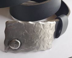 "Belt Buckle with either your initial on the front or artist's signature. Signed original belt buckle. Silver hand forged buckle with bronze  signature, or silver.  Hypoallergenic stainless steel buckle fits 1.5\" belt for jeans. Favourite us on Etsy to get the latest...hot off the anvil! https://www.etsy.com/ca/shop/ironartcanada Each buckle comes with it's own gift bag.  Choose from black velvet or beige burlap at the time of purchase. Hypoallergenic buckle. Buckle measures 3-1/4\" x 2\" . Han Vintage Belt Buckles With Belt For Gift, Classic Silver Buckle Belt Buckles As Gift, Classic Silver Belt Buckles, Classic Silver Buckle Belt As Gift, Artisan Engraved Belt Buckles For Gifts, Artisan Engraved Belt Buckles As Gift, Silver Engraved Belt For Gift, Silver Engraved Belt As Gift, Modern Silver Adjustable Belt Buckles