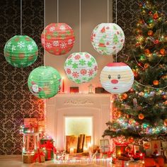 christmas decorations are hanging from the ceiling in front of a fire place and decorated tree