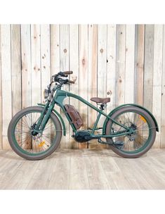 an old fashioned bicycle is parked in front of a wooden wall with planks on it