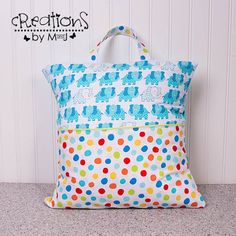 a colorful polka dot bag sitting on top of a counter next to a wall with the words creations by my