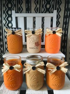 six mason jars are sitting on a bench