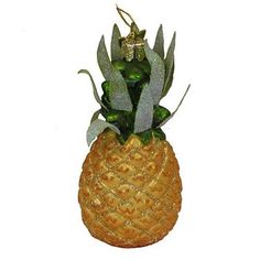 a pineapple shaped planter with green leaves