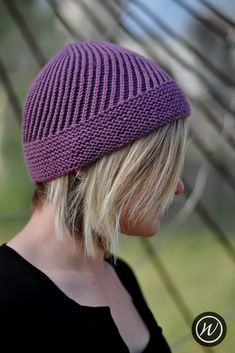 a woman wearing a purple knitted hat