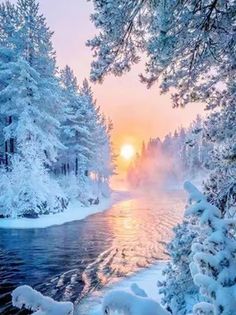 the sun is setting over a river surrounded by snow covered trees