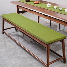 a table with two benches and a bowl of fruit on it