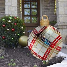 a christmas ornament in front of a house