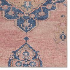 an antique rug with blue and pink colors