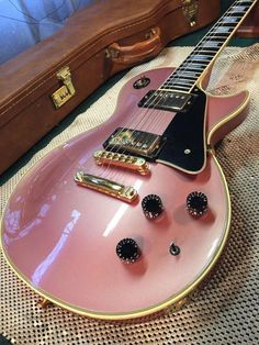 a pink guitar sitting on top of a table