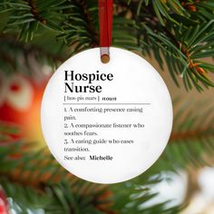 a white ornament hanging from a christmas tree with the words'hospice nurse '