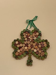 a bottle cap christmas tree ornament made from wine corks and green ribbon