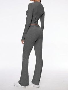 Step out in style with our contemporary two-piece set, combining comfort and fashion in one. The ensemble features a body-hugging crop top with long sleeves and matching low-rise pants with a gentle flare. Each piece is crafted from high-quality modal fabric that's both soft to the touch and elastic for durability. Features: Quality Fabric: The set is made from premium modal, known for its softness and elasticity, ensuring both comfort and longevity. Chic Design: With a round neckline and croppe Fitted Two-piece Set With Long Sleeves, Solid Fitted Long Sleeve Sets, Solid Color Fitted Long Sleeve Sets, Fitted Wide Leg Solid Color Sets, Fitted Solid Color Wide Leg Sets, Solid Color Fitted Wide Leg Sets, Stretch Long Sleeve Pant Set For Loungewear, Fitted Two-piece Wide Leg Pant Set, Chic Fitted Cropped Pant Set