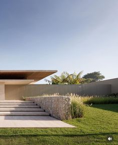 an outdoor area with steps leading up to the roof and grass in front of it