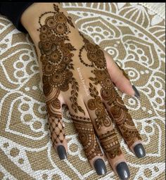 a woman's hands with hennap on top of her arm and hand