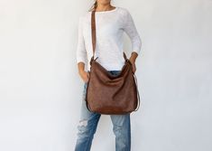 "Convertible leather bag: Converts from backpack to shoulder bag and crossbody bag with the single use of one strap. The main style of the bag is a soft and slouchy hobo bag. The permanent long strap on the bag can be easily adjusted to your desired length in order to wear the bag on your shoulder, as a crossbody bag or as a backpack. **Important point is that when you adjust the strap to a backpack the strap is stable and does not slide from one side to the other. Made from soft Italian distres Hobo Bag With Detachable Strap For On-the-go, Hobo Shoulder Bag With Adjustable Strap, On-the-go Hobo Satchel With Adjustable Strap, Versatile Soft Leather Backpack, Versatile Crossbody Hobo Bag With Adjustable Strap, On-the-go Hobo Shoulder Bag With Detachable Handle, Chic Hobo Backpack Bag For On-the-go, Versatile Shoulder Bag With Detachable Handle And Backpack Shape, On-the-go Hobo Bag With Detachable Handle