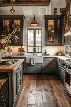 a kitchen with wooden floors and gray cabinets