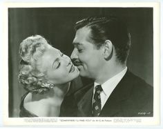 an old black and white photo of a man kissing a woman