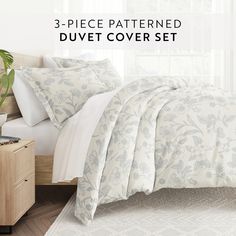 three piece patterned duvet cover set in white and blue floral print with matching pillow cases